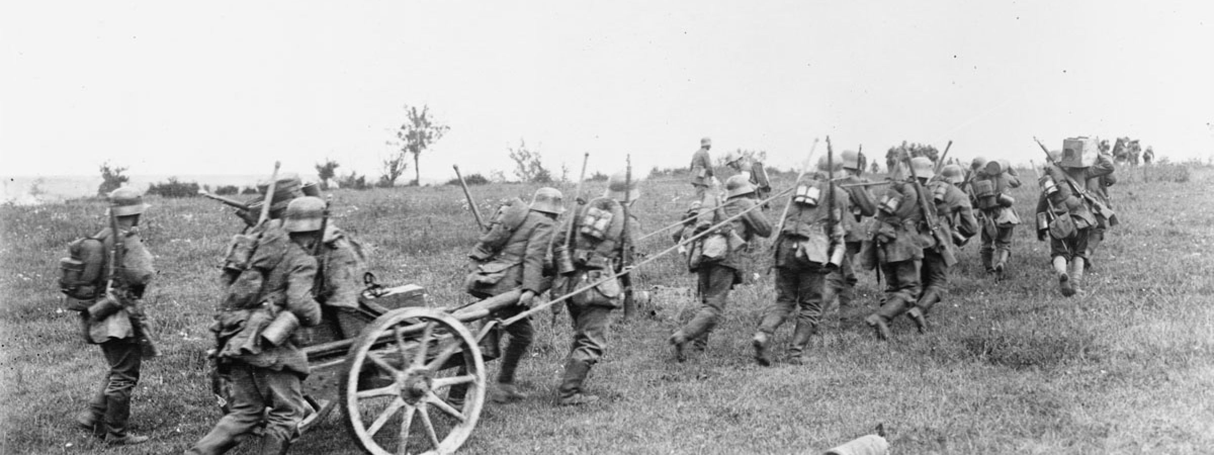 German soldiers haul a granatenwerfer - a type of grenade or mortar thrower - forward in support of advancing stormtroops, 15 July 1918.